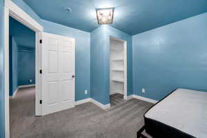 Carpeted bedroom featuring baseboards