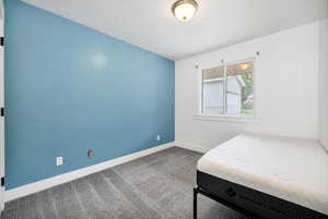 Carpeted bedroom with baseboards