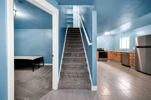 Stairs featuring wood tiled floor and baseboards
