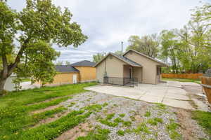 Back of house with a patio and fence