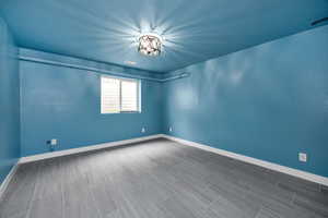 Empty room featuring baseboards and visible vents