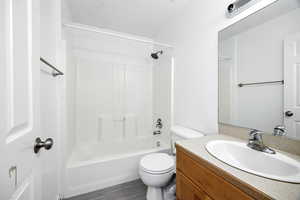 Full bathroom featuring toilet, shower / bathing tub combination, and vanity