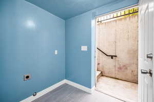 Laundry area featuring baseboards, hookup for an electric dryer, and laundry area