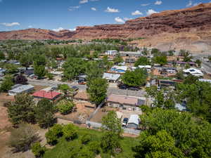 Aerial view of property and surrounding area with a mountainous background