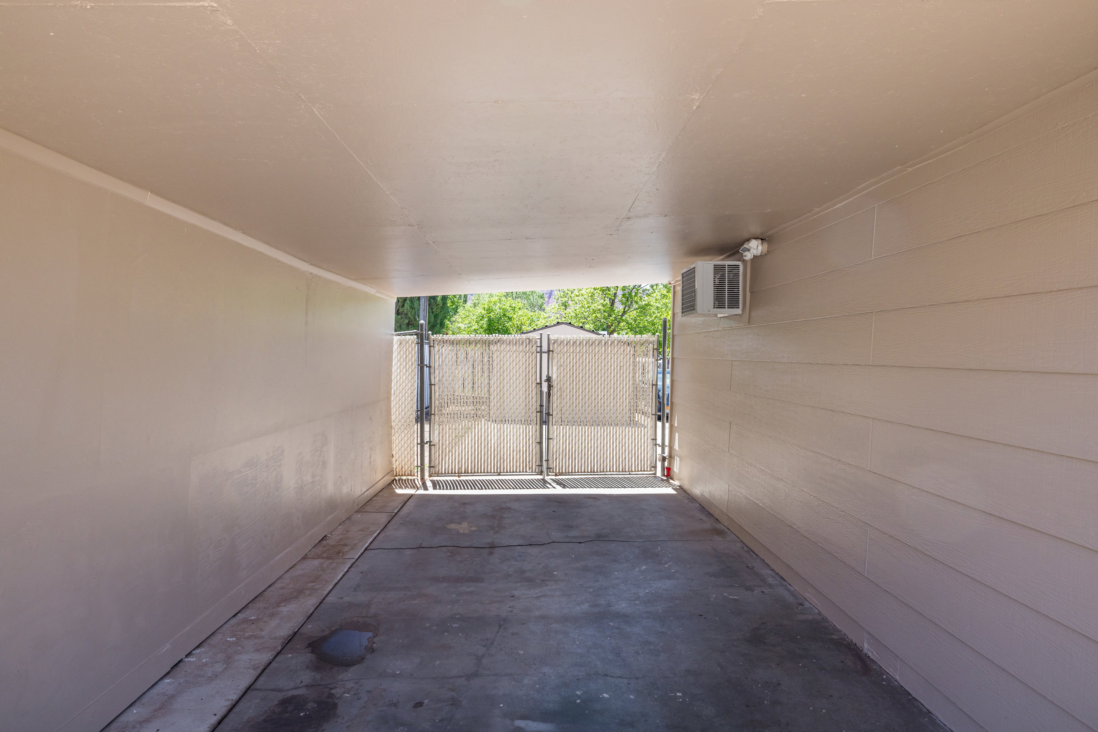View of carport with a gate