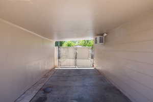 View of carport with a gate