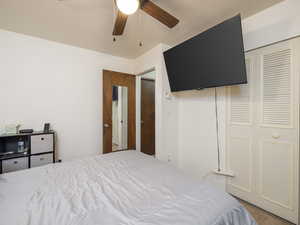 Bedroom with a closet, lvp floors, and a ceiling fan