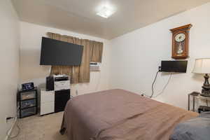 Bedroom with light carpet and cooling unit