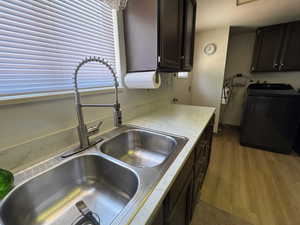 Kitchen featuring washer / dryer, w/ NEW LPV floors, new countertops, and dark brown cabinetry
