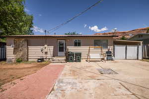 View of front facade with fence, a carport, and a gate
