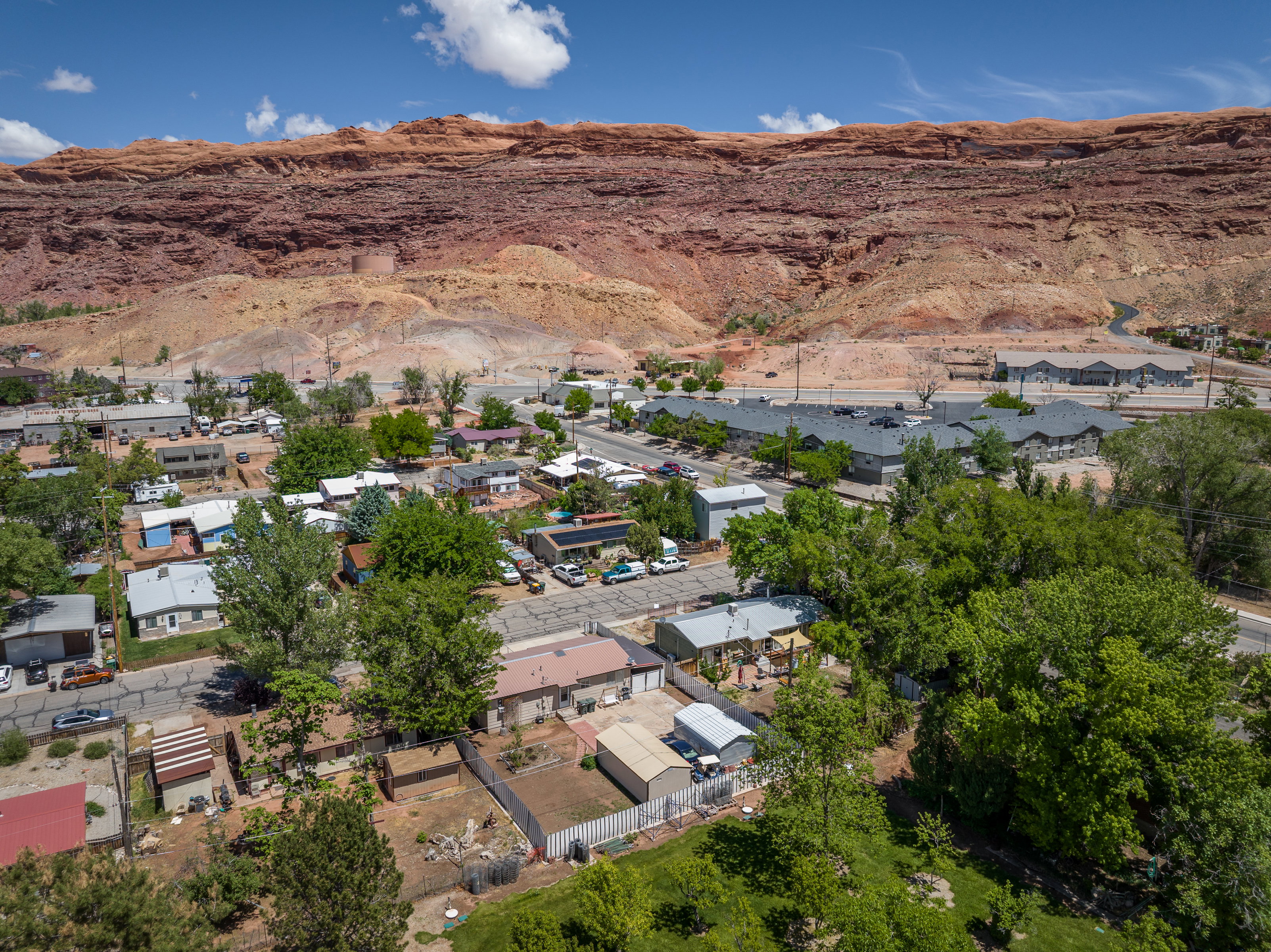 Aerial view of property's location with mountains and nearby suburban area