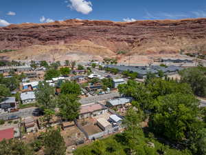 Aerial view of property's location with mountains and nearby suburban area