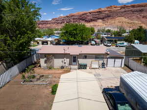 View of front of home with a mountain view and a fenced backyard