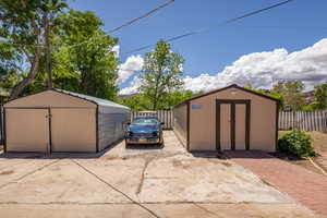 View of shed featuring fence