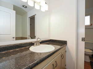 Bathroom featuring vanity and toilet