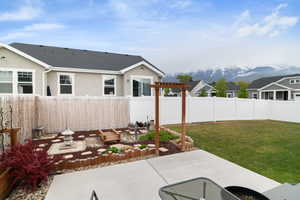 View of yard with a patio area, a pergola, and a mountain view