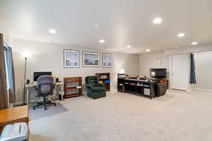 Office area featuring recessed lighting, light carpet, and baseboards