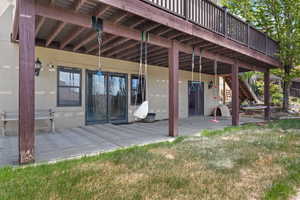 Rear view of house featuring a patio area, stairway, and stucco siding
