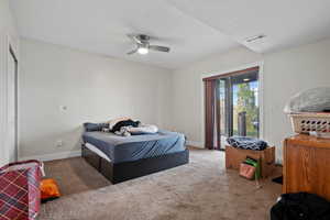 Carpeted bedroom featuring ceiling fan, access to outside, baseboards, and visible vents
