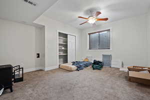 Interior space with ceiling fan, a closet, baseboards, and visible vents