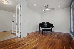 Living area featuring a ceiling fan, baseboards, recessed lighting, and hardwood / wood-style flooring