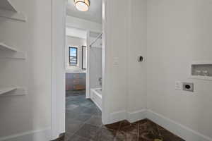 Clothes washing area with laundry area, electric dryer hookup, baseboards, and hookup for a washing machine