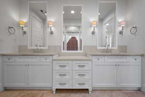 Full bath with two vanities and a sink