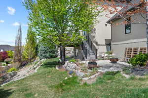 View of yard featuring stairway and a patio
