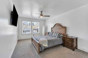 Bedroom with ceiling fan, light carpet, baseboards, and visible vents