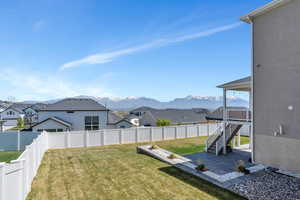 View of yard with a patio, a residential view, a mountain view, and a fenced backyard