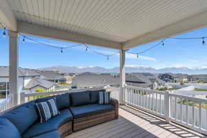 Wooden terrace featuring an outdoor hangout area, a residential view, and a mountain view
