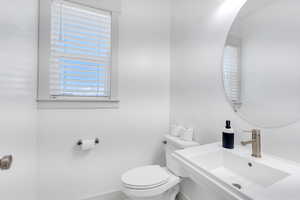 Half bath featuring a sink and toilet