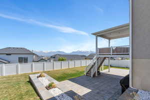 View of patio / terrace featuring stairway, a mountain view, and a fenced backyard