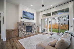 Living room with a fireplace, recessed lighting, and wood finished floors