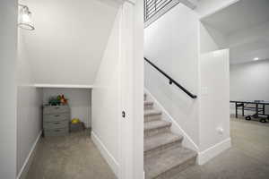 Stairway featuring carpet flooring and baseboards