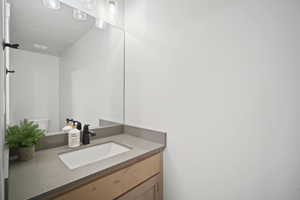 Half bath featuring toilet and vanity