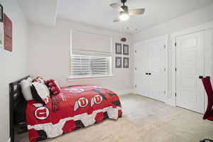 Bedroom featuring baseboards, a closet, a ceiling fan, and carpet floors