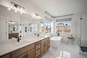 Full bathroom with a sink, double vanity, and a stall shower