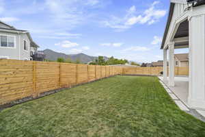 View of yard featuring a fenced backyard, a patio, and a mountain view