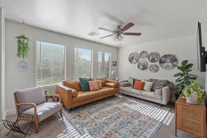 Living room featuring a wealth of natural light, carpet, and visible vents