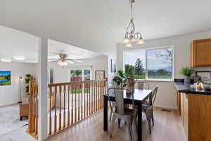 Dining room featuring light wood-type flooring, baseboards, and a ceiling fan