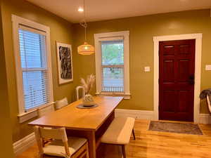 Dining space with light wood-type flooring, baseboards, and recessed lighting