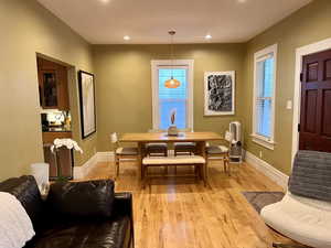 Dining area featuring light wood-style flooring, baseboards, and recessed lighting