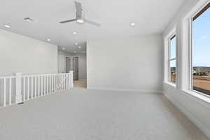 Empty room featuring recessed lighting, light carpet, ceiling fan, and baseboards