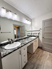 Bathroom featuring a sink, double vanity, and a textured ceiling