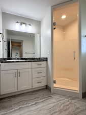 Full bathroom with a stall shower and vanity