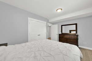 Bedroom with carpet, baseboards, and a closet