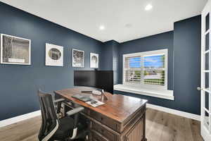 Office featuring light wood-style flooring, baseboards, and recessed lighting