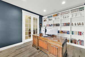 Office area with french doors, light wood-style flooring, and recessed lighting