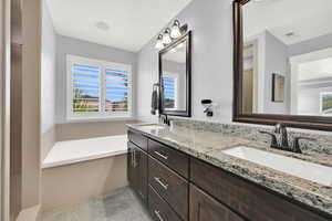Full bath featuring a garden tub and double vanity